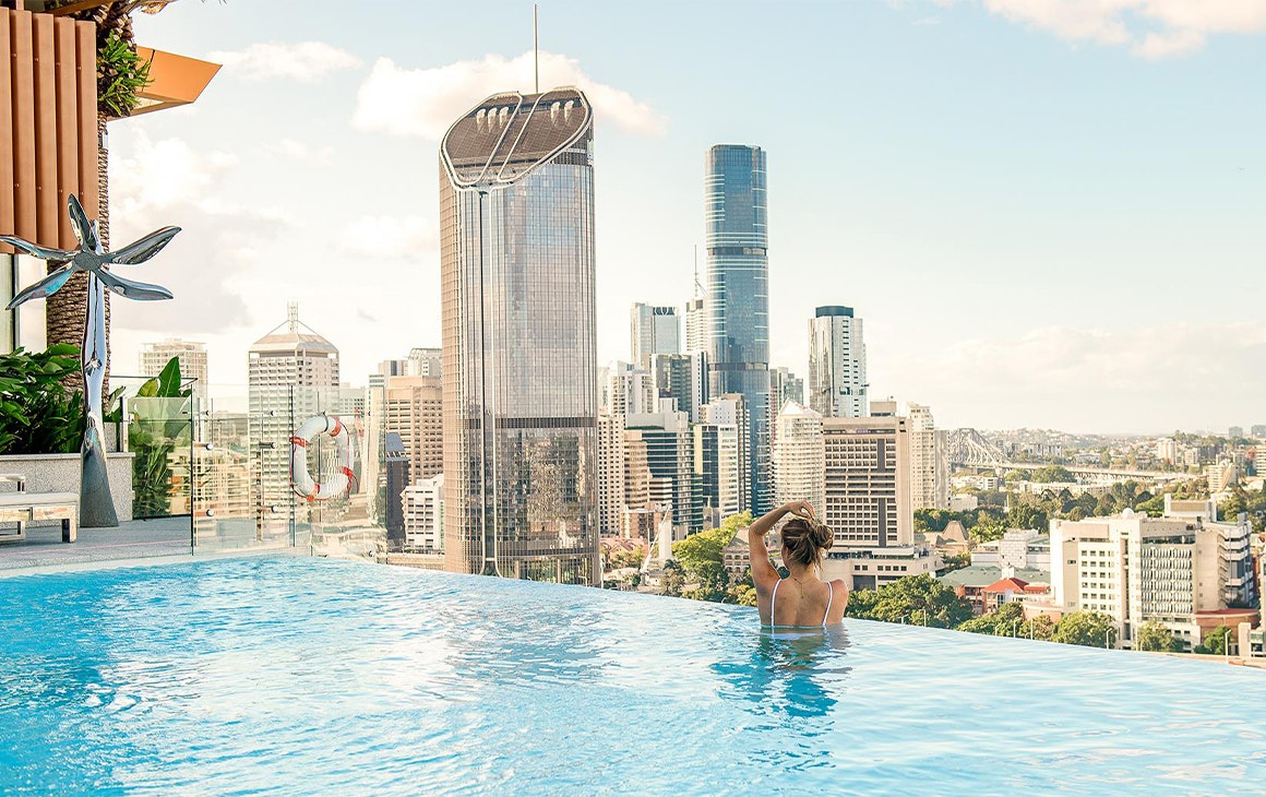 an infinity pool overlooking the brisbane city skyline